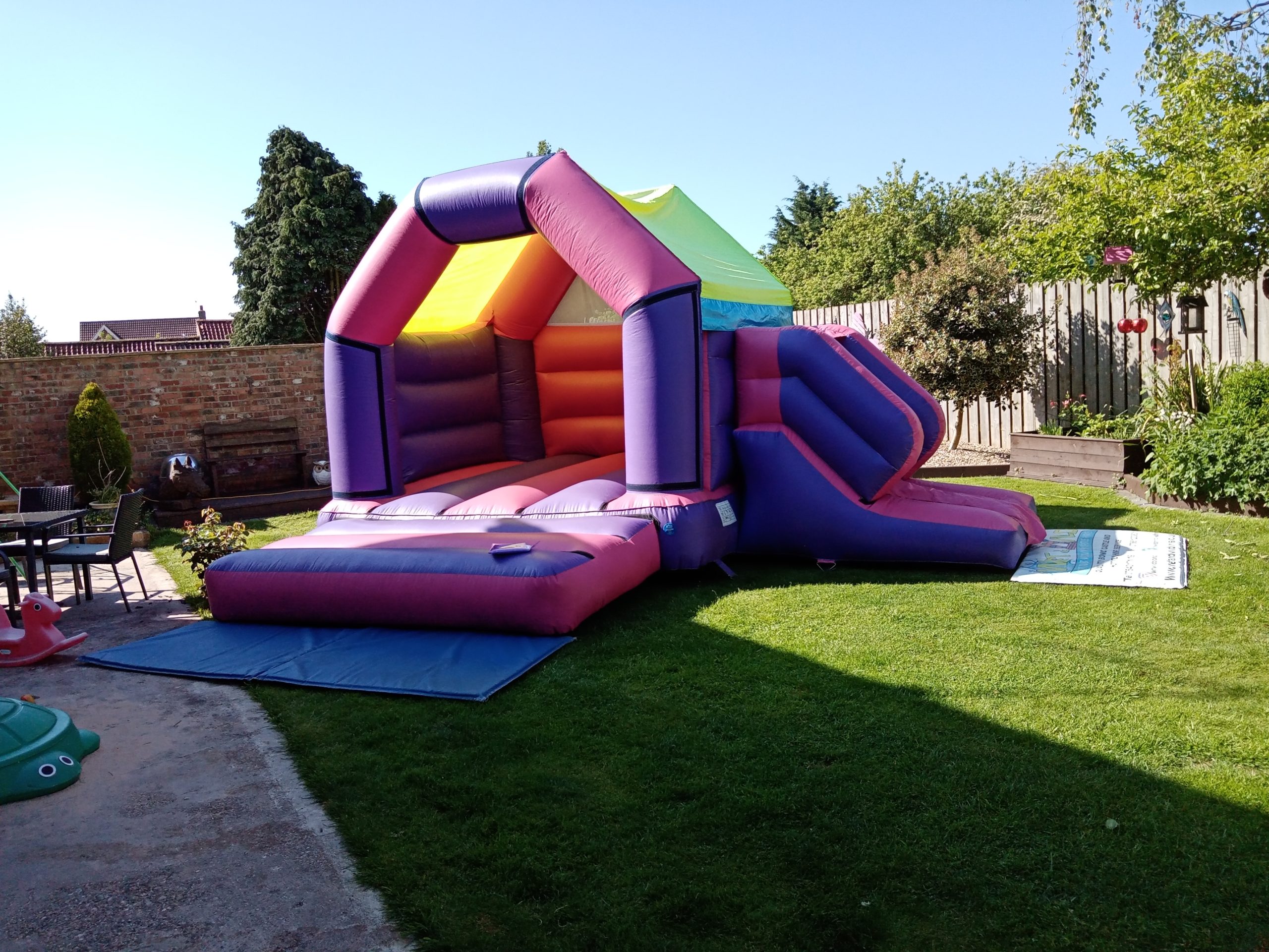 Large bouncy castle with slide, ideal for a summer party